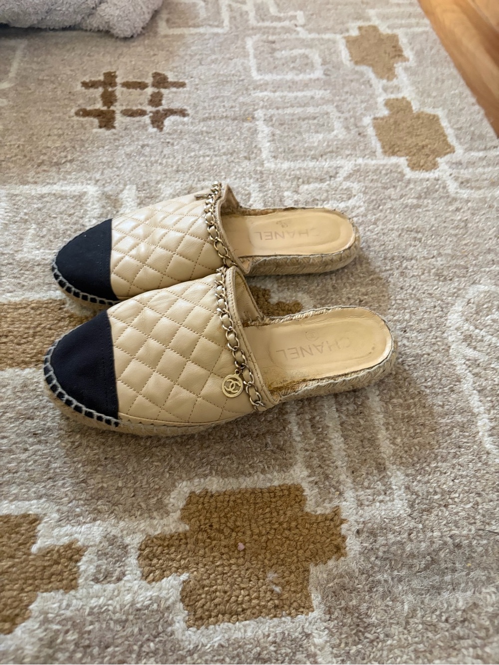 CHANEL Quilted Leather Slide Mules in Beige and Black with Gold Chain